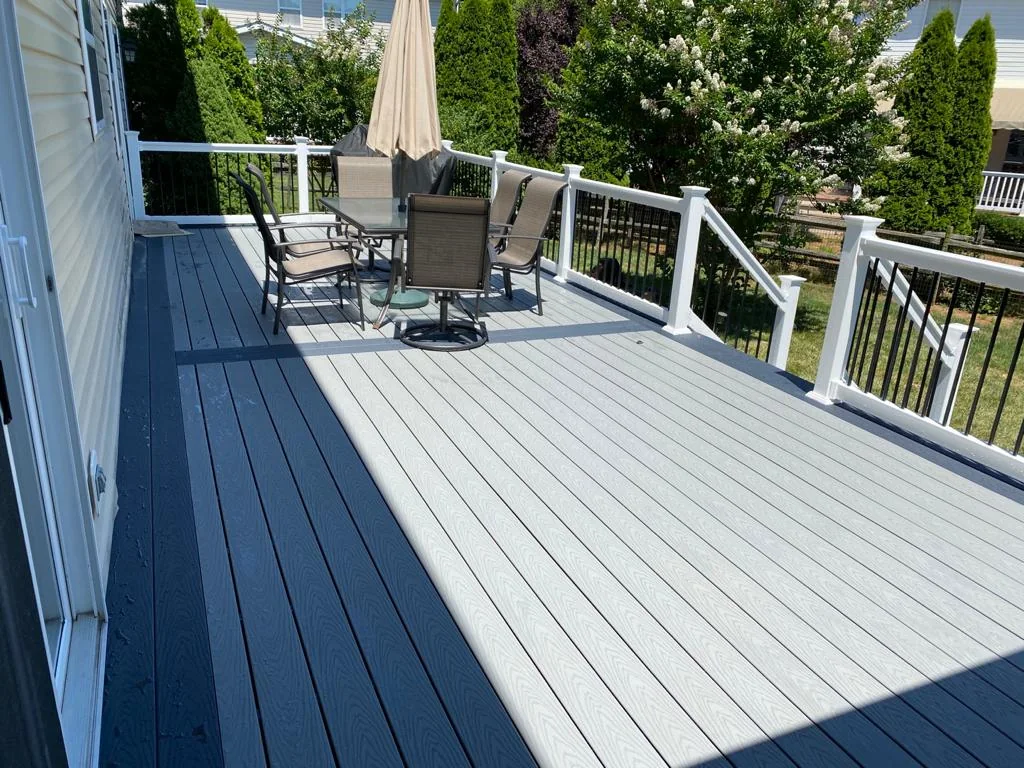 Gray deck with white railings and outdoor furniture
