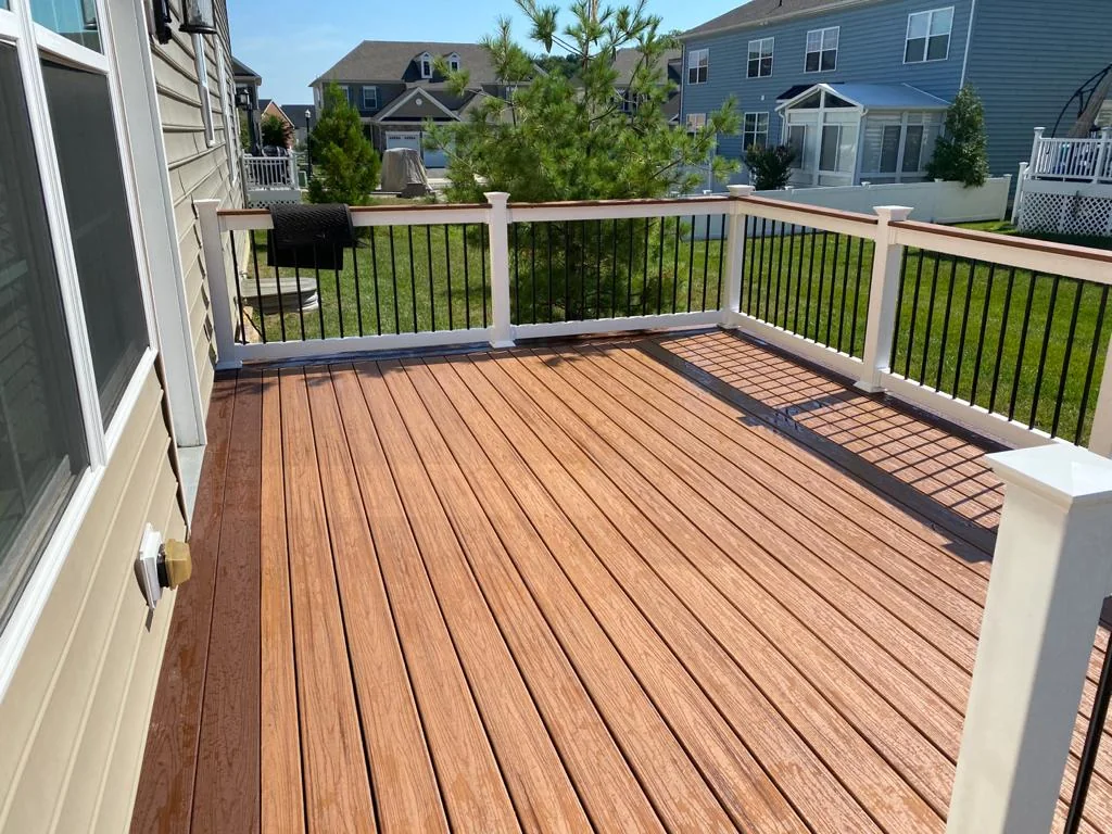 Brown deck and white railing at a home