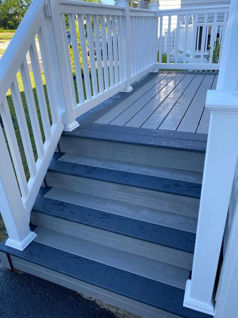 Blue-gray deck stairs with white railings