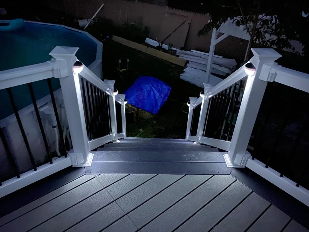 Outdoor staircase and illuminated deck railing at night