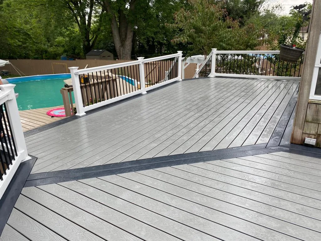 Gray deck and railing overlooking a yard