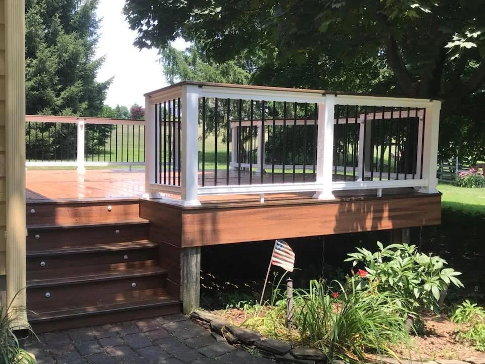 Elevated deck with stairs and white railing