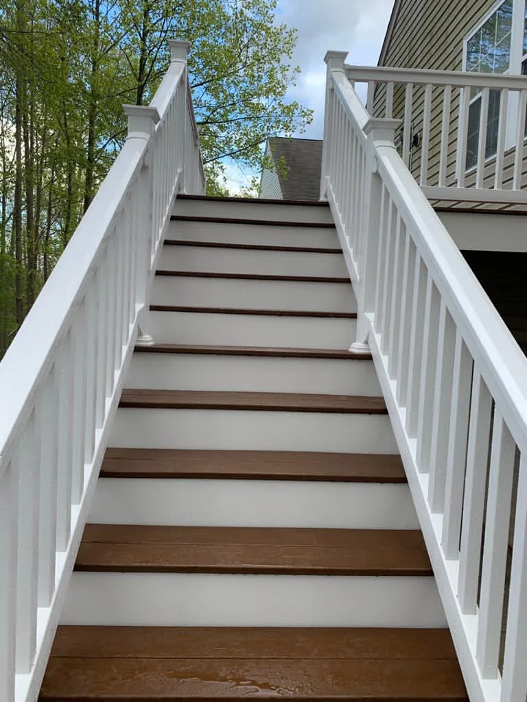 Outdoor staircase with composite treads and white railings