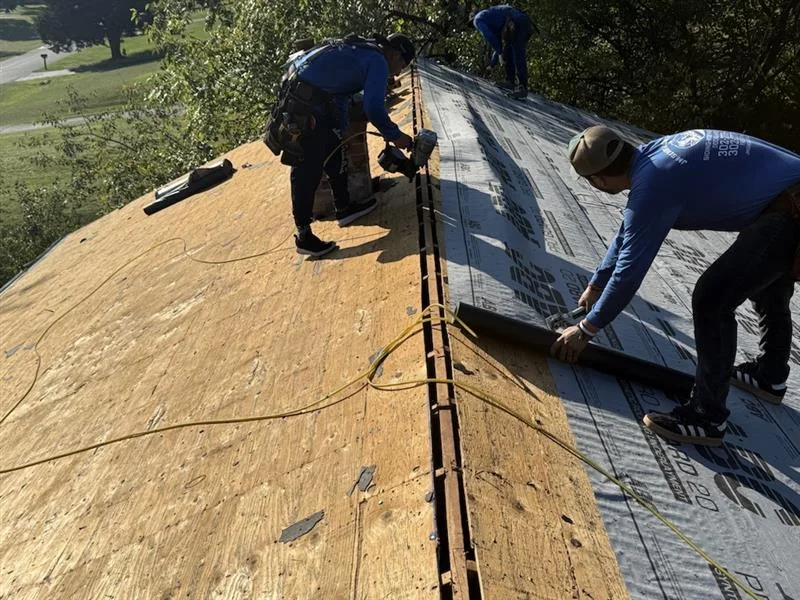Roofing crew working on a residential home
