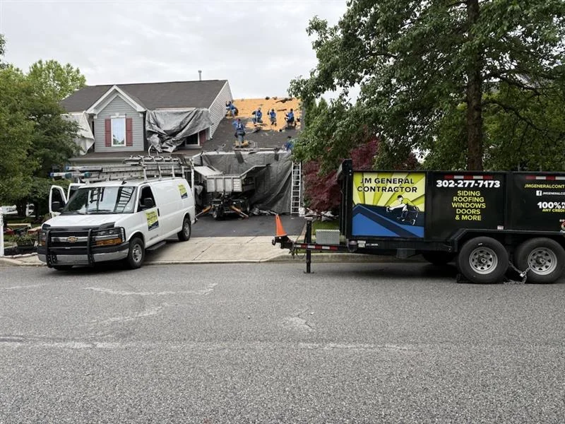 JM General Contractors vehicles at a project site