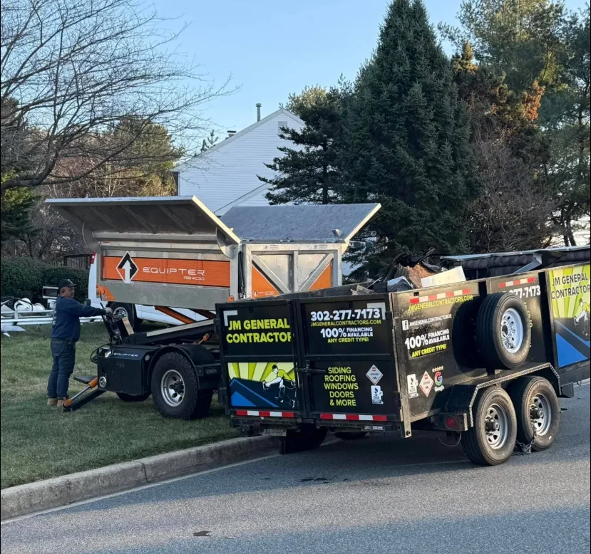 JM General Contractors truck and trailer at a job site