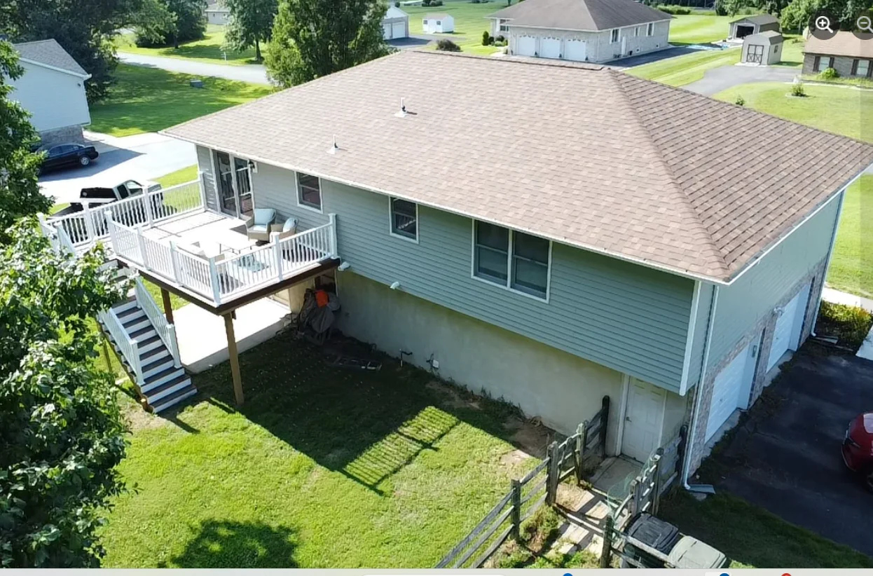 Aerial view of a residential roof and backyard deck