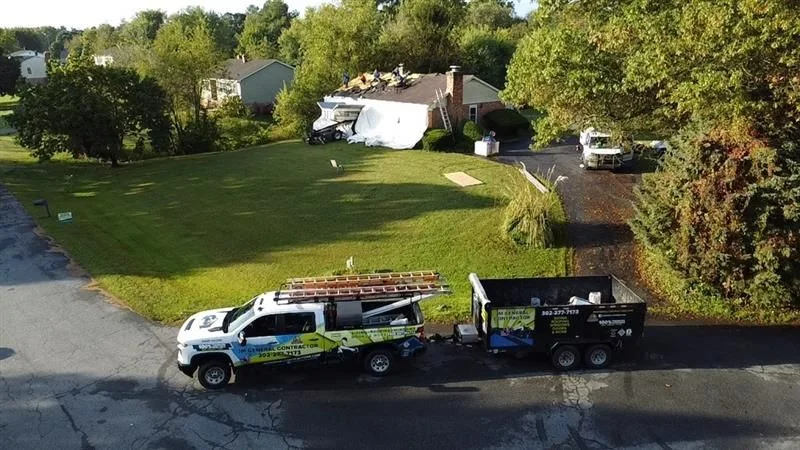 JM General Contractors vehicles beside a finished home