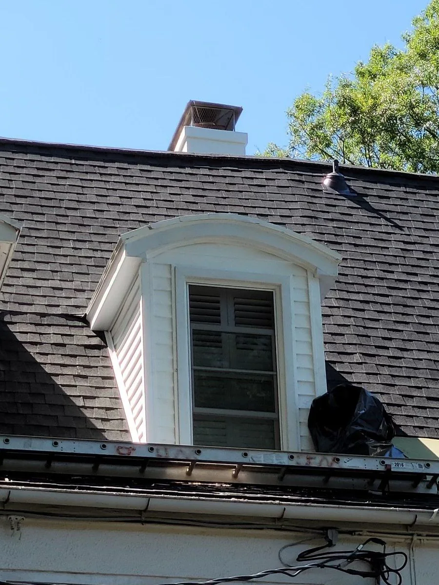 Finished shingles around a roof dormer
