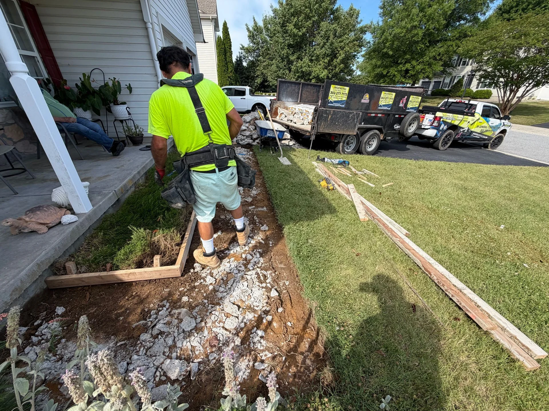 Worker building forms for a concrete path