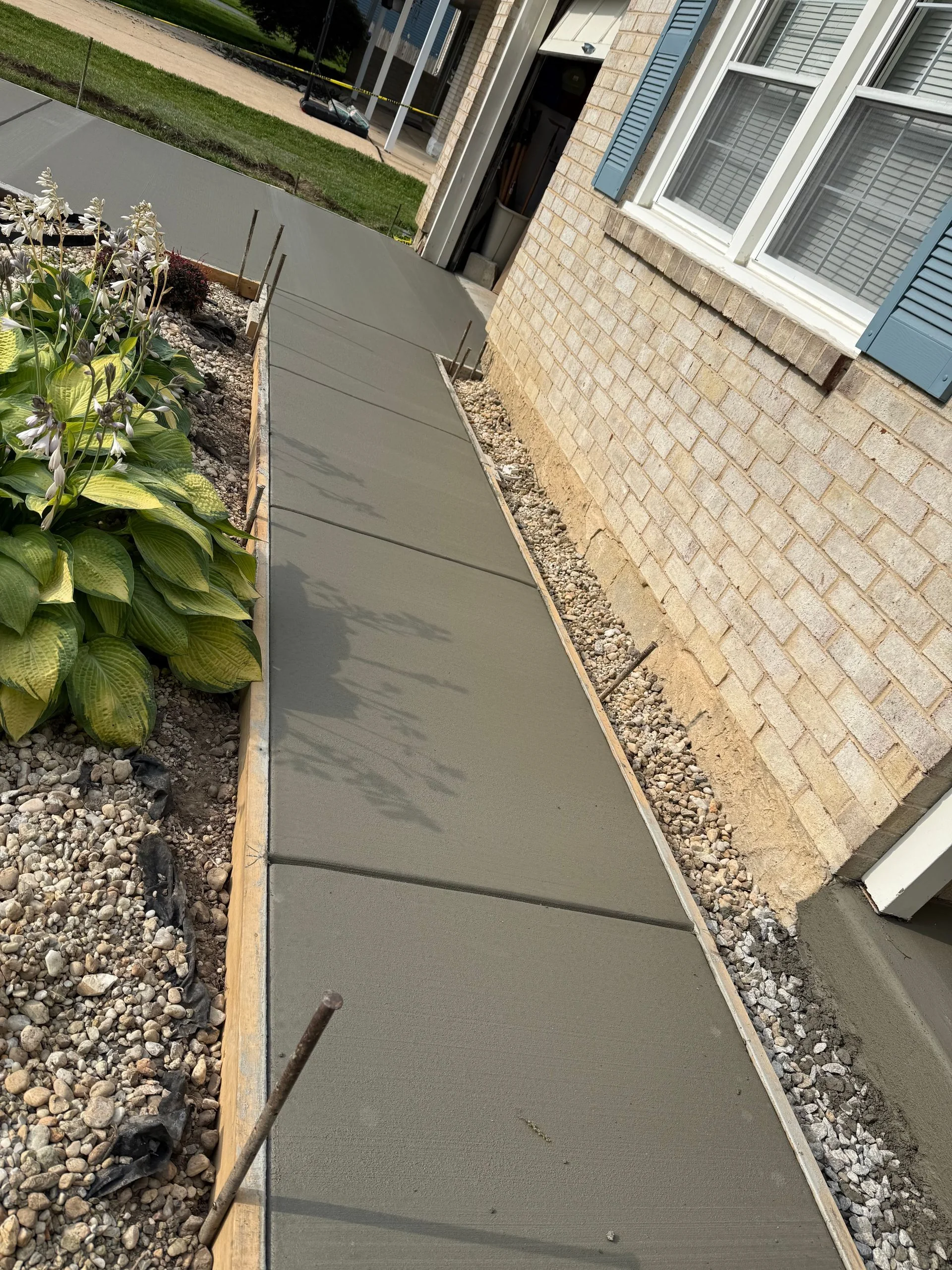 Fresh concrete walkway beside a home