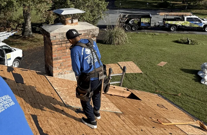 Roofer standing on roof sheathing during construction